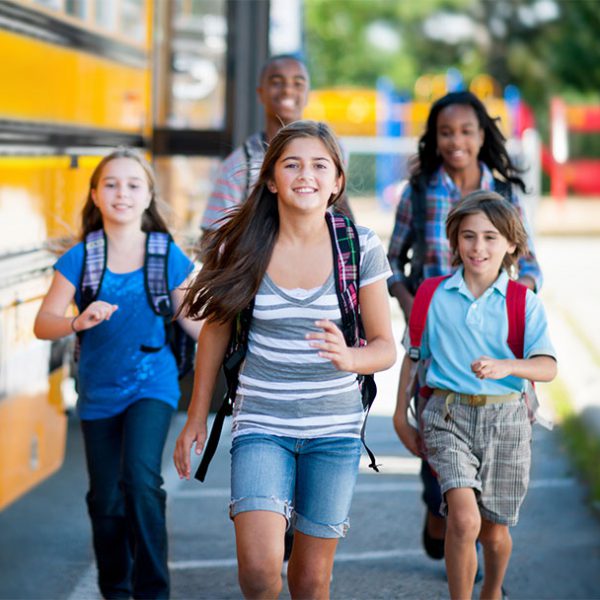 School safety makes kids smiling walking to school.