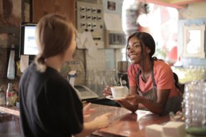 Local community barista serving coffee