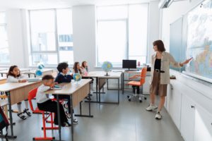 Teacher stands before classroom